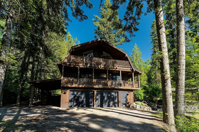 151 Handkerchief Creek Dr, Kalispell, MT 59901 - view of front of property featuring driveway, an attached garage, and a wooden deck