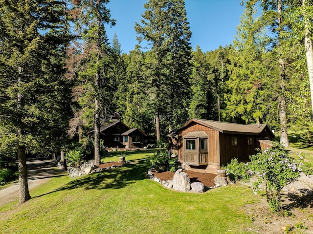 151 Handkerchief Creek Dr, Kalispell, MT 59901 - view of grassy yard with an outbuilding and a wooded view