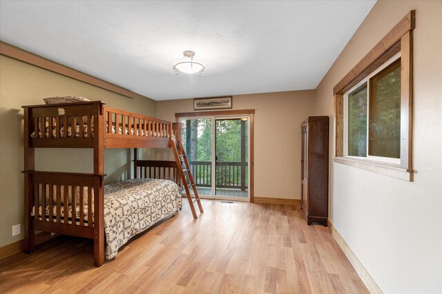 151 Handkerchief Creek Dr, Kalispell, MT 59901 - bedroom with light wood-style floors and access to outside