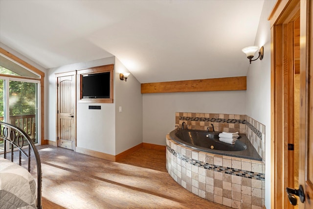 151 Handkerchief Creek Dr, Kalispell, MT 59901 - bedroom with vaulted ceiling, wood finished floors, and access to exterior