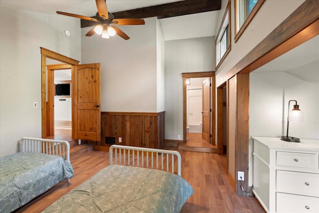 151 Handkerchief Creek Dr, Kalispell, MT 59901 - bedroom with wood finished floors, high vaulted ceiling, wainscoting, and wood walls