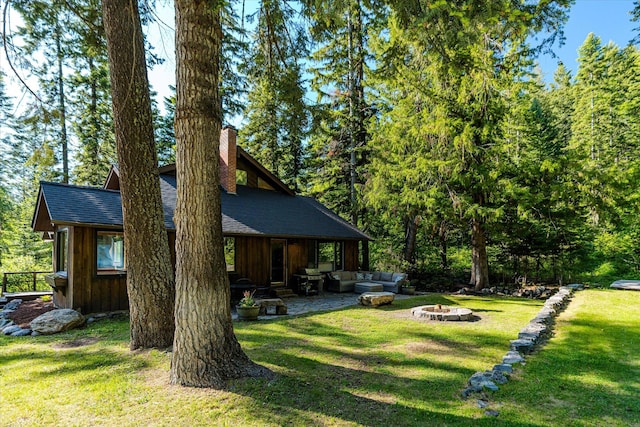 151 Handkerchief Creek Dr, Kalispell, MT 59901 - view of grassy yard with an outdoor living space with a fire pit and a patio area