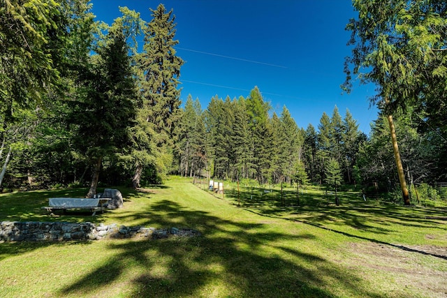 151 Handkerchief Creek Dr, Kalispell, MT 59901 - view of green lawn with a forest view