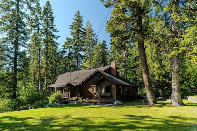 151 Handkerchief Creek Dr, Kalispell, MT 59901 - chalet / cabin with a chimney and a front yard