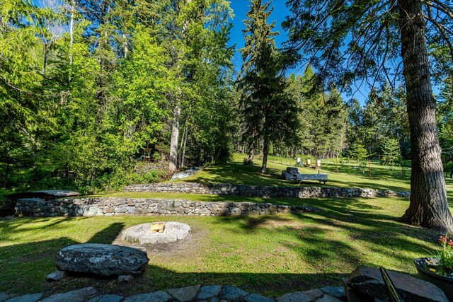 151 Handkerchief Creek Dr, Kalispell, MT 59901 - view of grassy yard featuring a fire pit