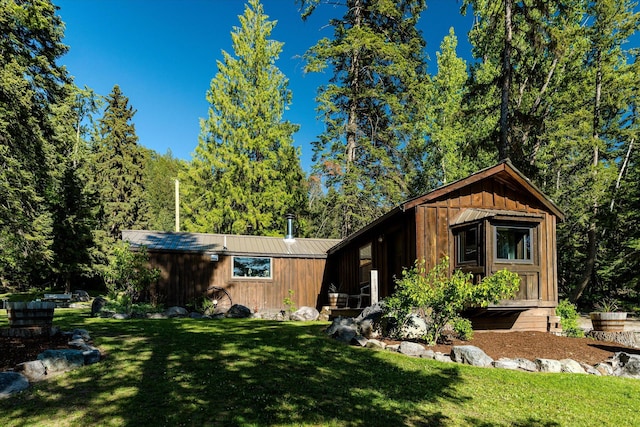 151 Handkerchief Creek Dr, Kalispell, MT 59901 - view of front of house featuring a front yard, board and batten siding, and a metal roof