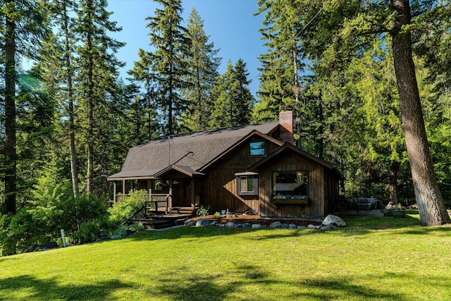 151 Handkerchief Creek Dr, Kalispell, MT 59901 - rustic home featuring a chimney and a front yard