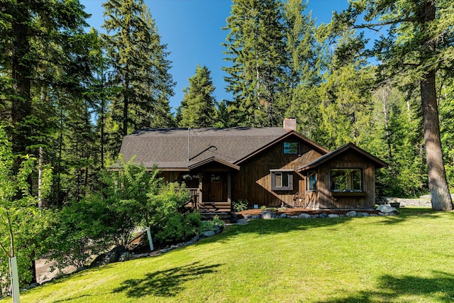 151 Handkerchief Creek Dr, Kalispell, MT 59901 - view of front facade featuring a chimney, a front yard, and a shingled roof