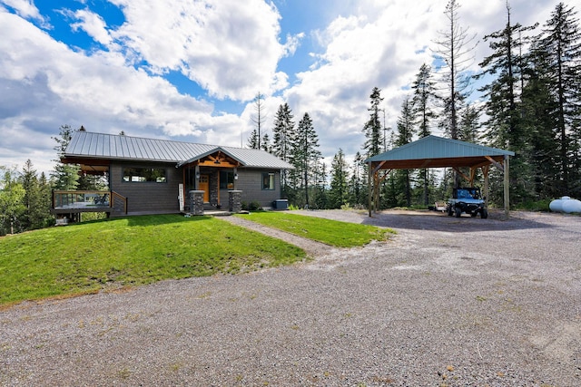 4111 Foothill Rd, Kalispell, MT 59901 - view of front of property with a front yard, a detached carport, driveway, and a metal roof