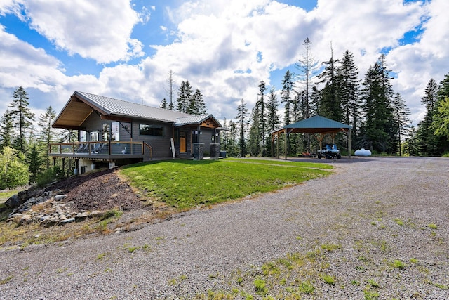 4111 Foothill Rd, Kalispell, MT 59901 - view of side of home featuring a gazebo, a lawn, a metal roof, and a deck