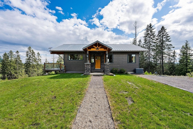 4111 Foothill Rd, Kalispell, MT 59901 - view of front of property with a front lawn, a metal roof, and stone siding