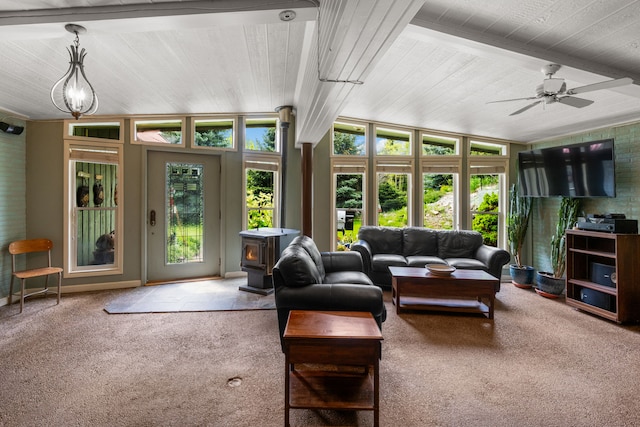 6040 Pearl Dr, Manhattan, MT 59741 - living area with a wood stove, carpet floors, wood ceiling with exposed beams, and ceiling fan