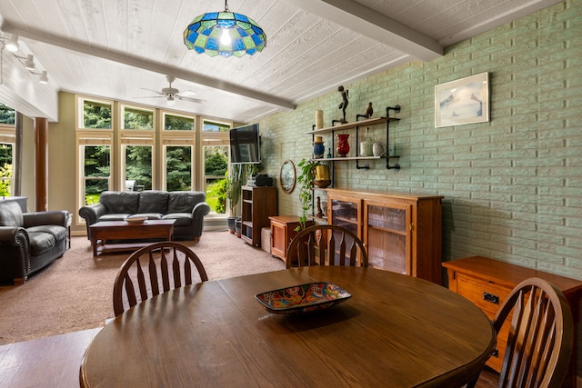 6040 Pearl Dr, Manhattan, MT 59741 - dining space featuring brick wall, a ceiling fan, wooden ceiling, and carpet