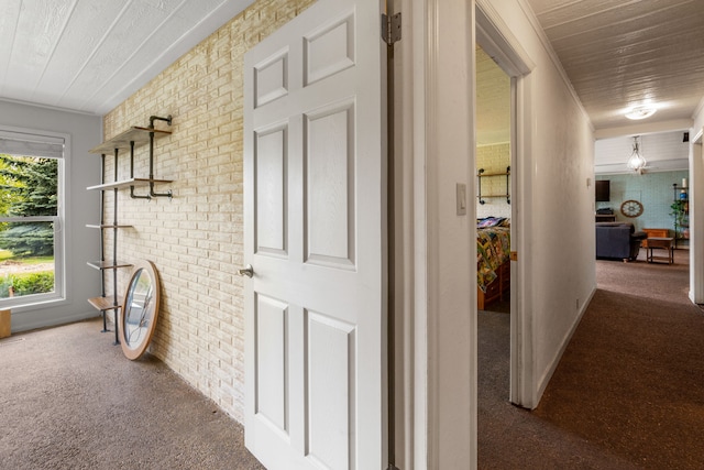6040 Pearl Dr, Manhattan, MT 59741 - hall with carpet flooring, wooden ceiling, and brick wall