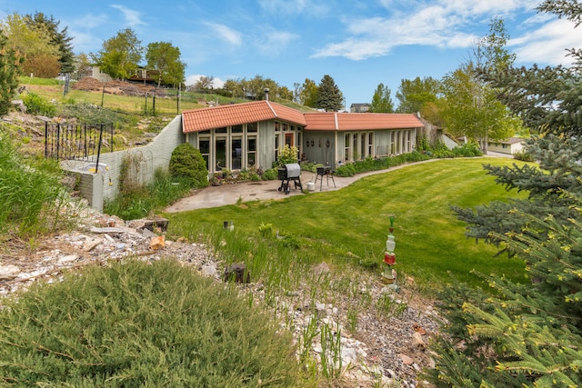 6040 Pearl Dr, Manhattan, MT 59741 - rear view of house with a patio, a yard, and a tiled roof