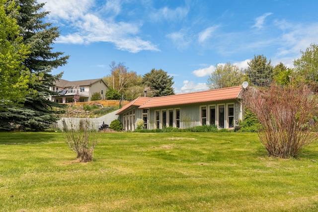 6040 Pearl Dr, Manhattan, MT 59741 - rear view of house featuring a yard and a tiled roof