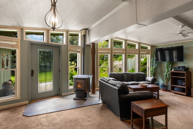 6040 Pearl Dr, Manhattan, MT 59741 - living room featuring carpet floors, wooden ceiling, baseboards, a wood stove, and a ceiling fan