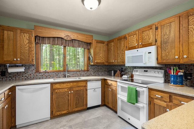 250 Sunday Ln, Kalispell, MT 59901 - kitchen featuring white appliances, a sink, and brown cabinets