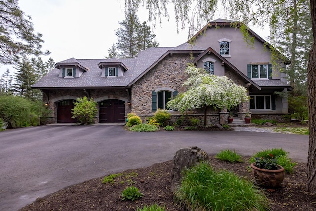 360 Plantation Dr, Kalispell, MT 59901 - view of front of property featuring stone siding, driveway, an attached garage, and stucco siding