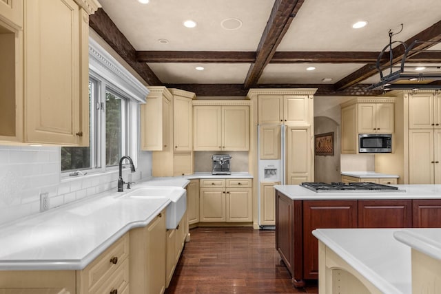 360 Plantation Dr, Kalispell, MT 59901 - kitchen featuring built in appliances, dark wood-type flooring, light countertops, decorative backsplash, and beam ceiling