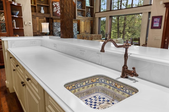 360 Plantation Dr, Kalispell, MT 59901 - kitchen with cream cabinets, a sink, light countertops, dark wood-style flooring, and open shelves