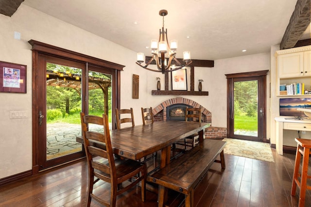 360 Plantation Dr, Kalispell, MT 59901 - dining space with a chandelier, dark wood-style floors, baseboards, recessed lighting, and a brick fireplace