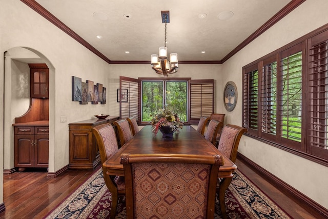 360 Plantation Dr, Kalispell, MT 59901 - dining area with dark wood finished floors, a chandelier, arched walkways, recessed lighting, and crown molding