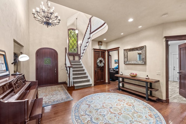 360 Plantation Dr, Kalispell, MT 59901 - entrance foyer featuring hardwood / wood-style floors, stairs, a high ceiling, arched walkways, and a chandelier