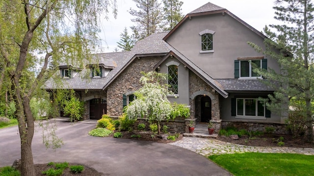 360 Plantation Dr, Kalispell, MT 59901 - view of front facade with stone siding, stucco siding, and asphalt driveway