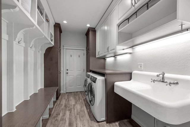 360 Plantation Dr, Kalispell, MT 59901 - washroom with washer and dryer, light wood-type flooring, recessed lighting, and cabinet space