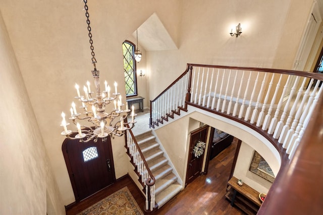 360 Plantation Dr, Kalispell, MT 59901 - entrance foyer with a towering ceiling, a chandelier, wood finished floors, stairway, and arched walkways