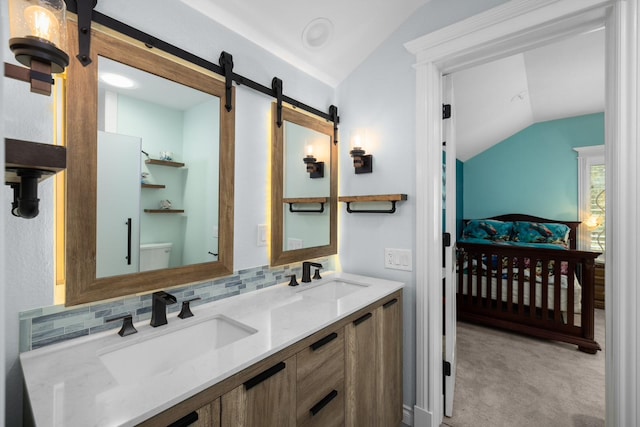 360 Plantation Dr, Kalispell, MT 59901 - bathroom featuring lofted ceiling, backsplash, double vanity, and toilet