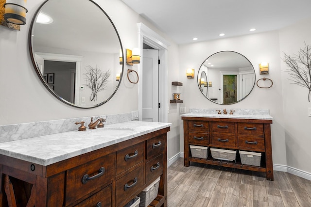 360 Plantation Dr, Kalispell, MT 59901 - bathroom with two vanities, wood finished floors, recessed lighting, and baseboards