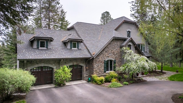 360 Plantation Dr, Kalispell, MT 59901 - french country home with stone siding, a garage, and driveway