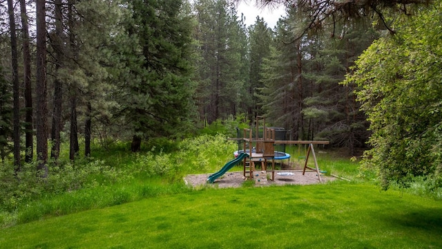 360 Plantation Dr, Kalispell, MT 59901 - view of play area with a forest view and a lawn