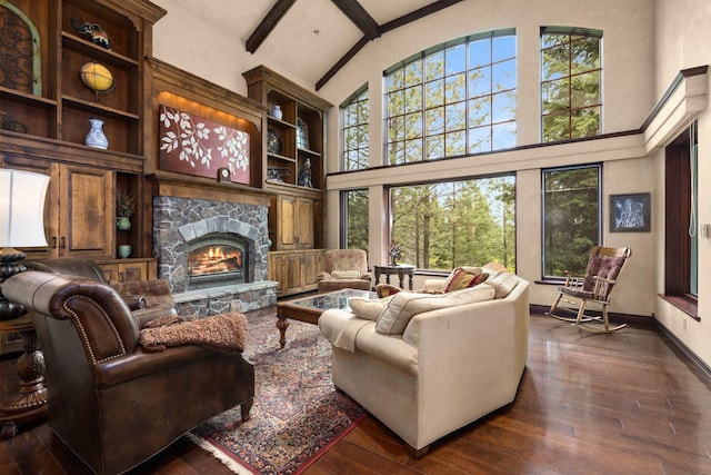 360 Plantation Dr, Kalispell, MT 59901 - living room with high vaulted ceiling, healthy amount of natural light, a stone fireplace, hardwood / wood-style flooring, and baseboards