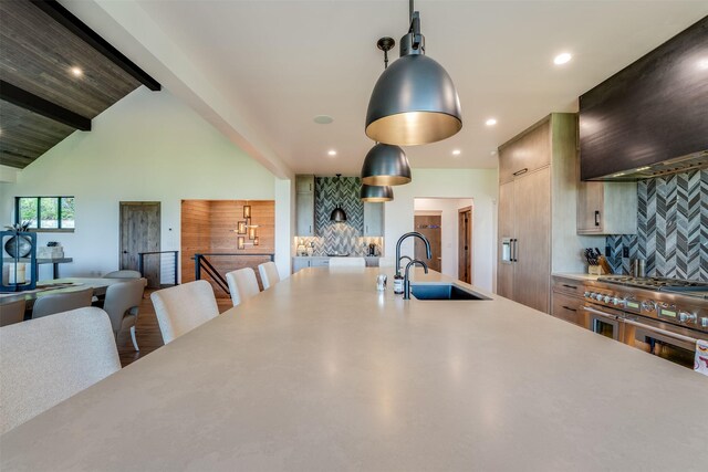 175 N Prairiesmoke Cir, Whitefish, MT 59937 - kitchen featuring a sink, backsplash, light countertops, extractor fan, and double oven range