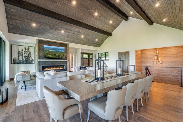 175 N Prairiesmoke Cir, Whitefish, MT 59937 - dining space with high vaulted ceiling, beamed ceiling, a fireplace, dark wood-type flooring, and recessed lighting