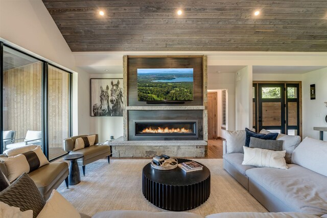 175 N Prairiesmoke Cir, Whitefish, MT 59937 - living room with wooden ceiling, vaulted ceiling, a stone fireplace, wood finished floors, and recessed lighting