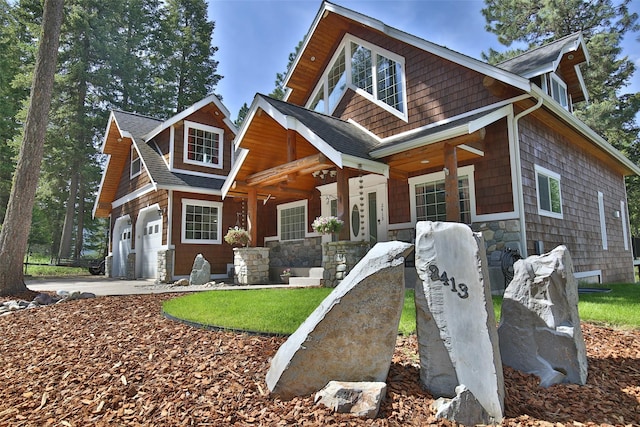 2413 Capstone Ct, Thompson Falls, MT 59873 - craftsman-style house with a porch, stone siding, driveway, and a shingled roof