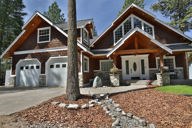 2413 Capstone Ct, Thompson Falls, MT 59873 - view of front of house with stone siding, covered porch, driveway, and a shingled roof
