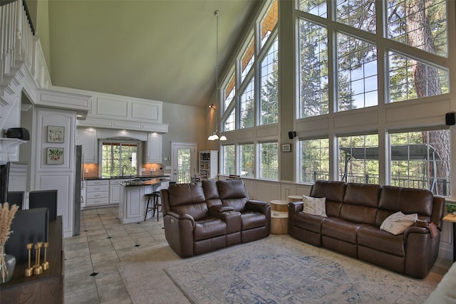 2413 Capstone Ct, Thompson Falls, MT 59873 - living room featuring a towering ceiling, healthy amount of natural light, light tile patterned floors, and a decorative wall