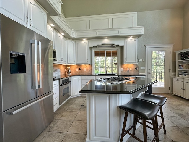 2413 Capstone Ct, Thompson Falls, MT 59873 - kitchen featuring appliances with stainless steel finishes, a sink, dark countertops, and plenty of natural light