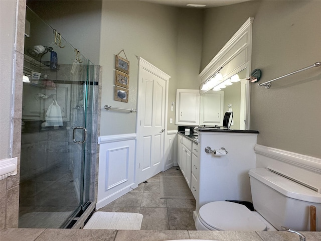 2413 Capstone Ct, Thompson Falls, MT 59873 - bathroom featuring toilet, vanity, a shower stall, and wainscoting