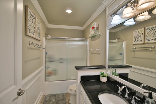 2413 Capstone Ct, Thompson Falls, MT 59873 - full bath featuring ornamental molding, vanity, toilet, a decorative wall, and bath / shower combo with glass door
