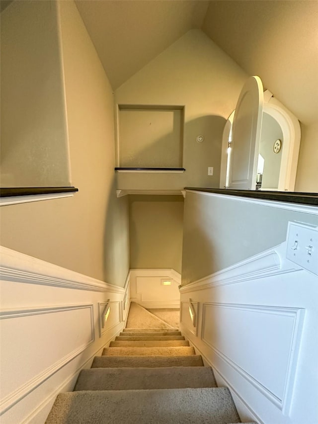 2413 Capstone Ct, Thompson Falls, MT 59873 - staircase featuring lofted ceiling and wainscoting