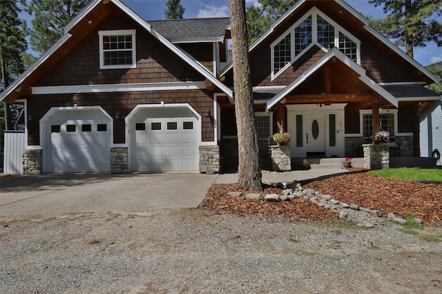 2413 Capstone Ct, Thompson Falls, MT 59873 - craftsman-style home with concrete driveway, stone siding, covered porch, and a garage