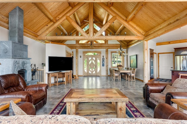 956 Falling Star Rd, Victor, MT 59875 - living room featuring a wooden ceiling with exposed beams, high vaulted ceiling, a chandelier, and a large fireplace
