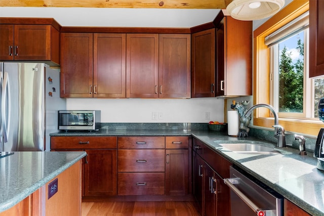 956 Falling Star Rd, Victor, MT 59875 - kitchen featuring stainless steel appliances, dark stone countertops, and light wood-style flooring