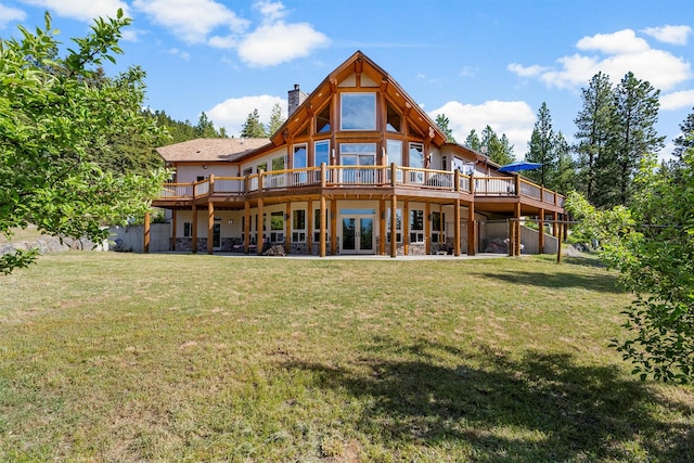 956 Falling Star Rd, Victor, MT 59875 - back of house featuring a deck, a chimney, a yard, and french doors
